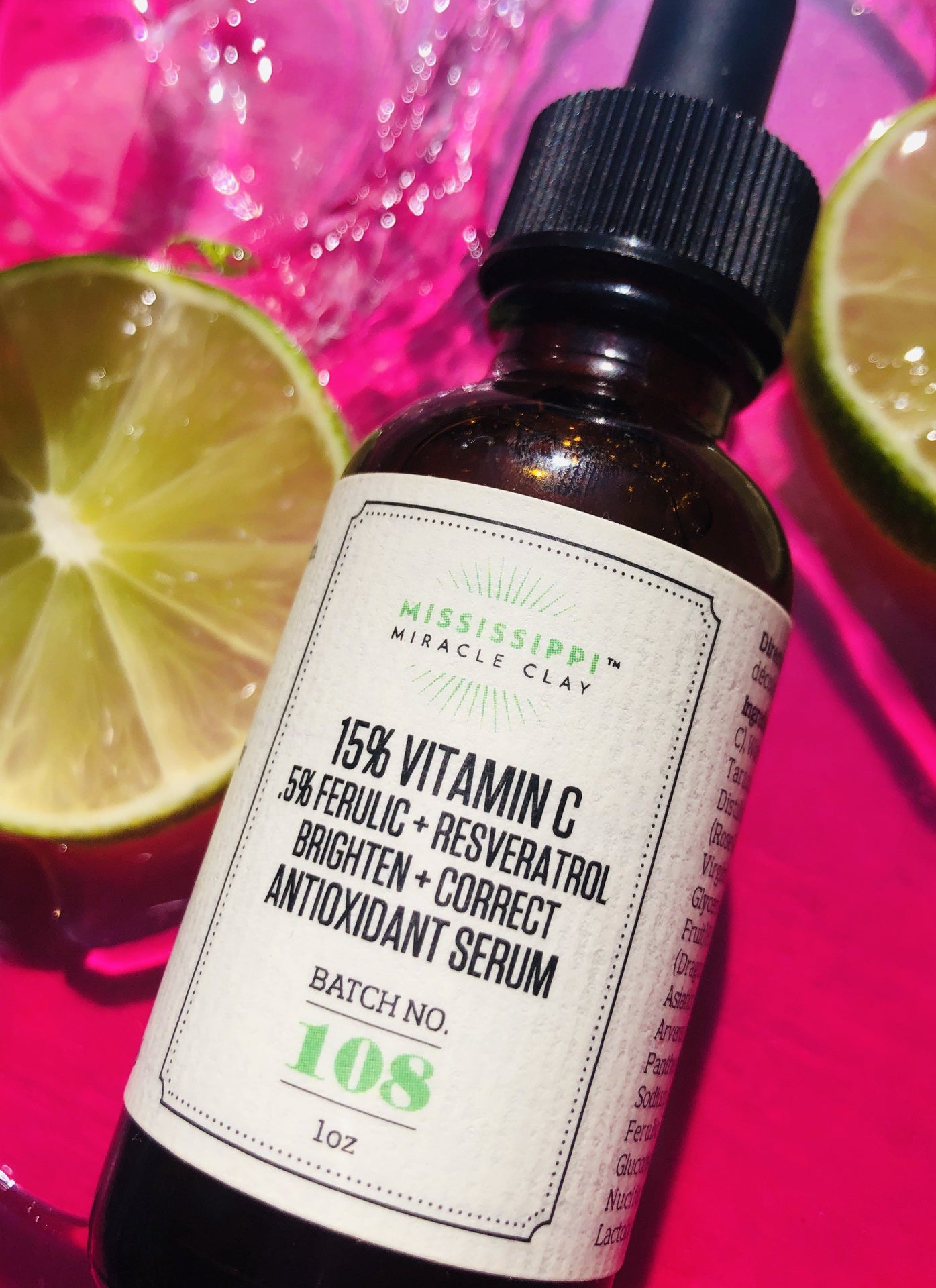 15% Vitamin C Serum on pink with fresh citrus