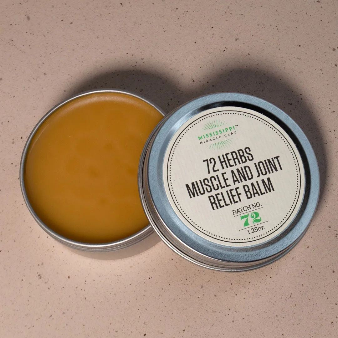 Open tin of 72 Herbs Muscle and Joint Relief Balm showing the herbal salve