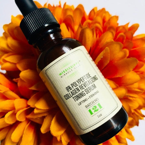8% Polypeptide Collagen Toning Serum on bright marigold flowers