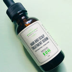 Hair and Scalp Treatment Serum dropper bottle on a soft green background