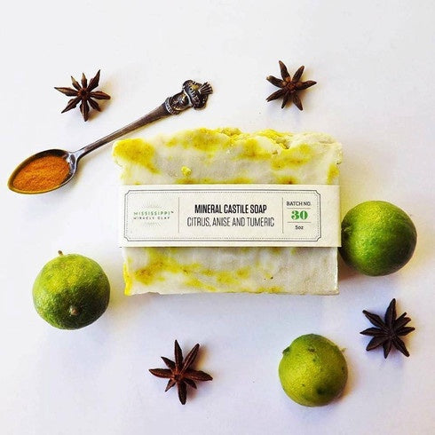 Citrus Turmeric Castile Soap with lime and star anise, showing its botanical ingredients