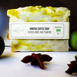 Citrus Turmeric Castile Soap bar standing with lime slices and star anise