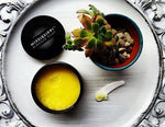 MMC Mineral Facial Oil in a dish on a silver tray with botanicals, a nourishing four-oil blend
