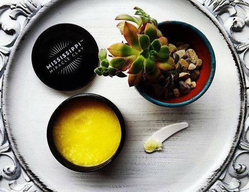 MMC Mineral Facial Oil in a dish on a silver tray with botanicals, a nourishing four-oil blend