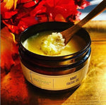 Open jar of MMC Mineral Facial Oil showing the golden oil blend in warm styling