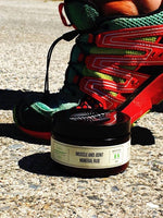 Muscle and Joint Mineral Rub beside hiking boots on a trail, natural relief after activity