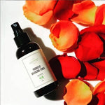 Probiotic Balancing Toner bottle with red rose petals