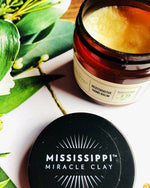 Restorative Hand Balm jar styled with tropical leaves