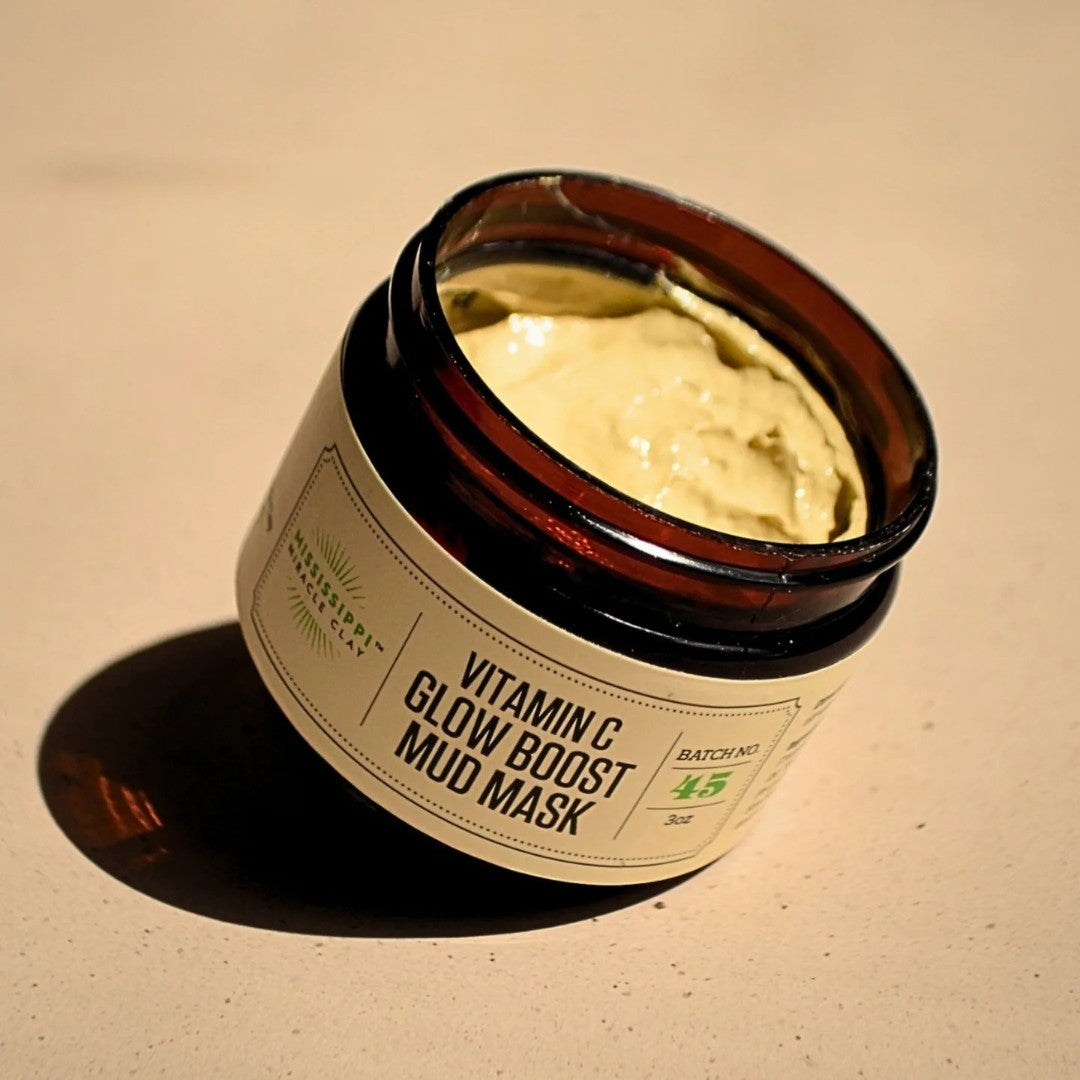 Vitamin C Glow Boost Mud Mask open jar showing the golden clay texture